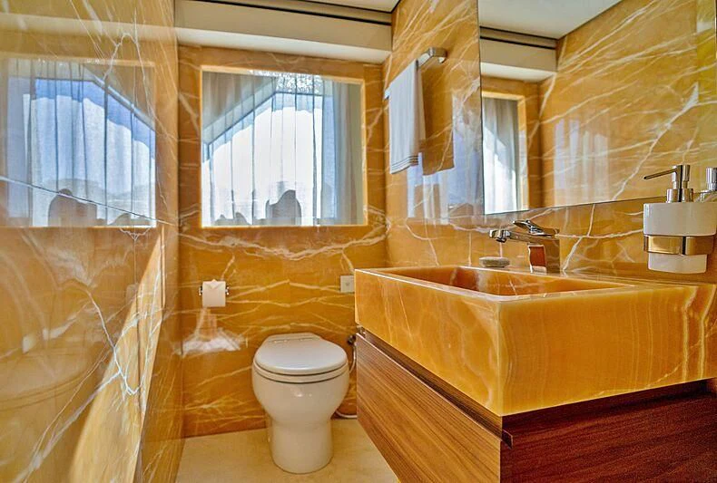 a bathroom with a tub sink and toilet aboard SUPERNOVA Yacht for Sale