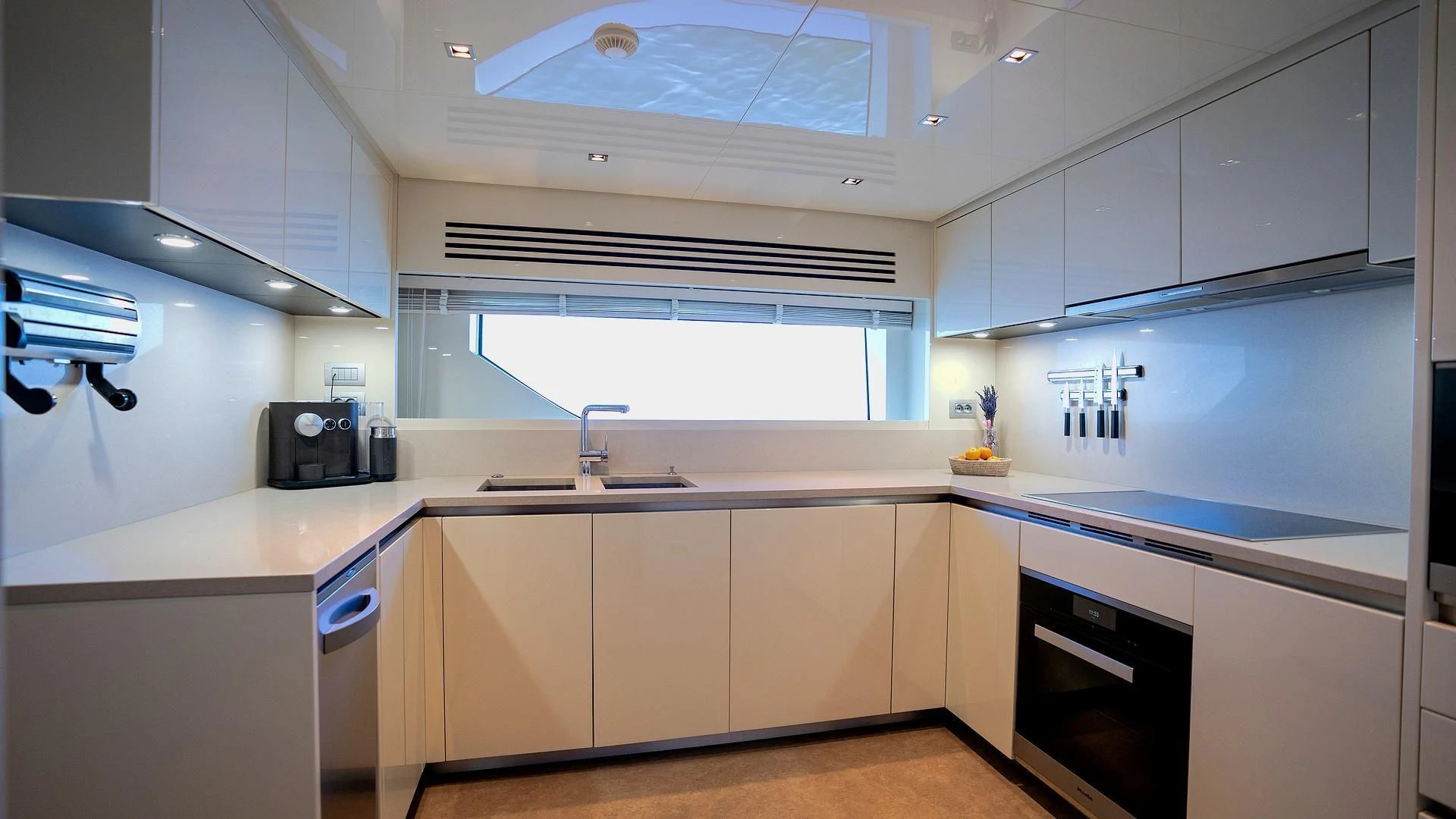 a kitchen with white cabinets aboard SUPERNOVA Yacht for Sale