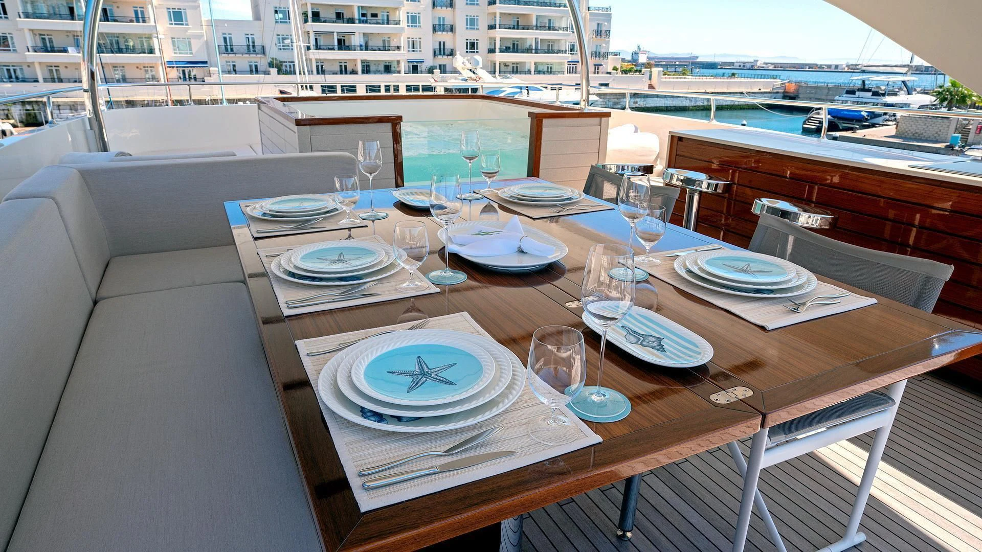 a table with plates and glasses on it aboard SUPERNOVA Yacht for Sale