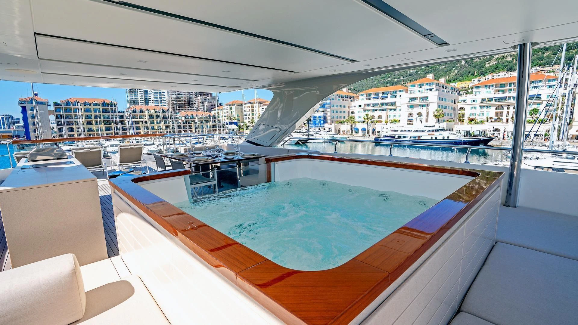 a large swimming pool in a large room with a city behind it aboard SUPERNOVA Yacht for Sale