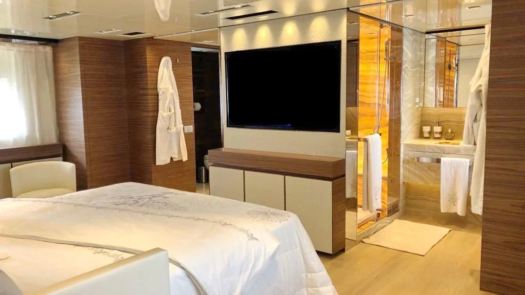 a room with a bed and a television aboard SUPERNOVA Yacht for Sale