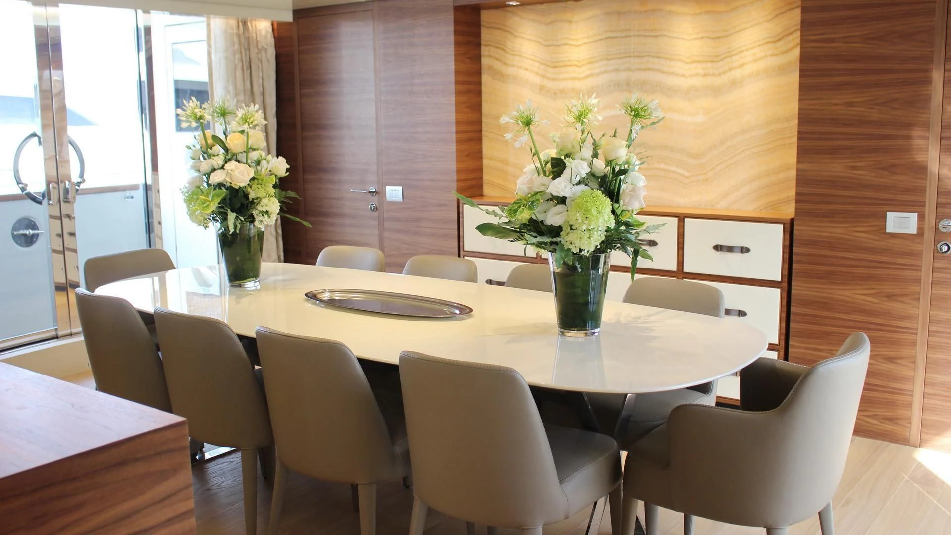 a table with chairs and flowers aboard SUPERNOVA Yacht for Sale