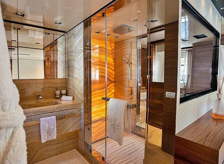 a bathroom with a glass shower aboard SUPERNOVA Yacht for Sale