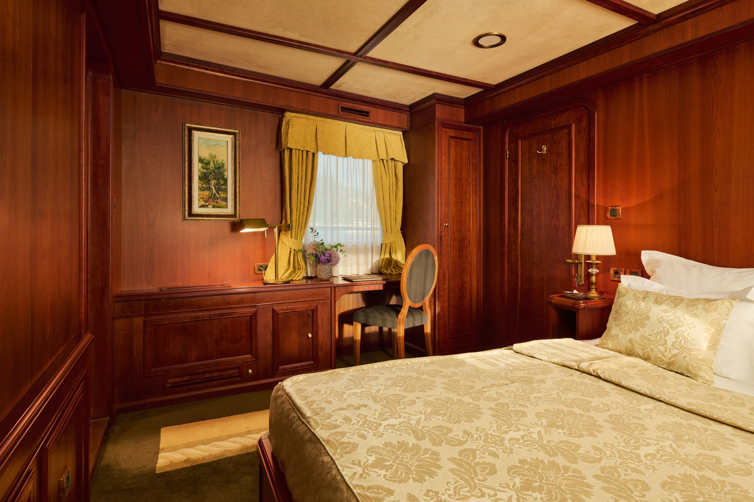 a bedroom with a bed and a chair aboard SEAGULL II Yacht for Sale