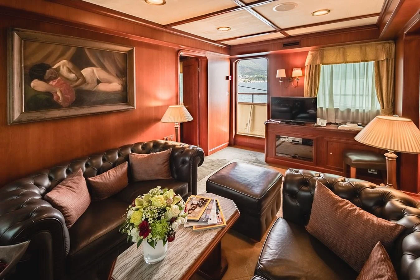 a living room with a leather couch and a television aboard SEAGULL II Yacht for Sale