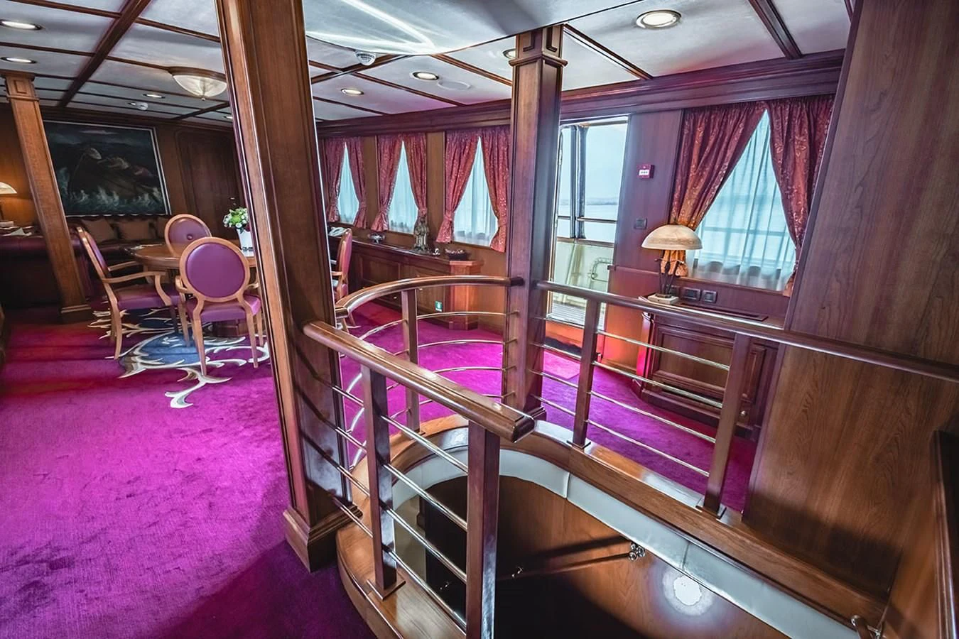 a room with a bench and chairs aboard SEAGULL II Yacht for Sale