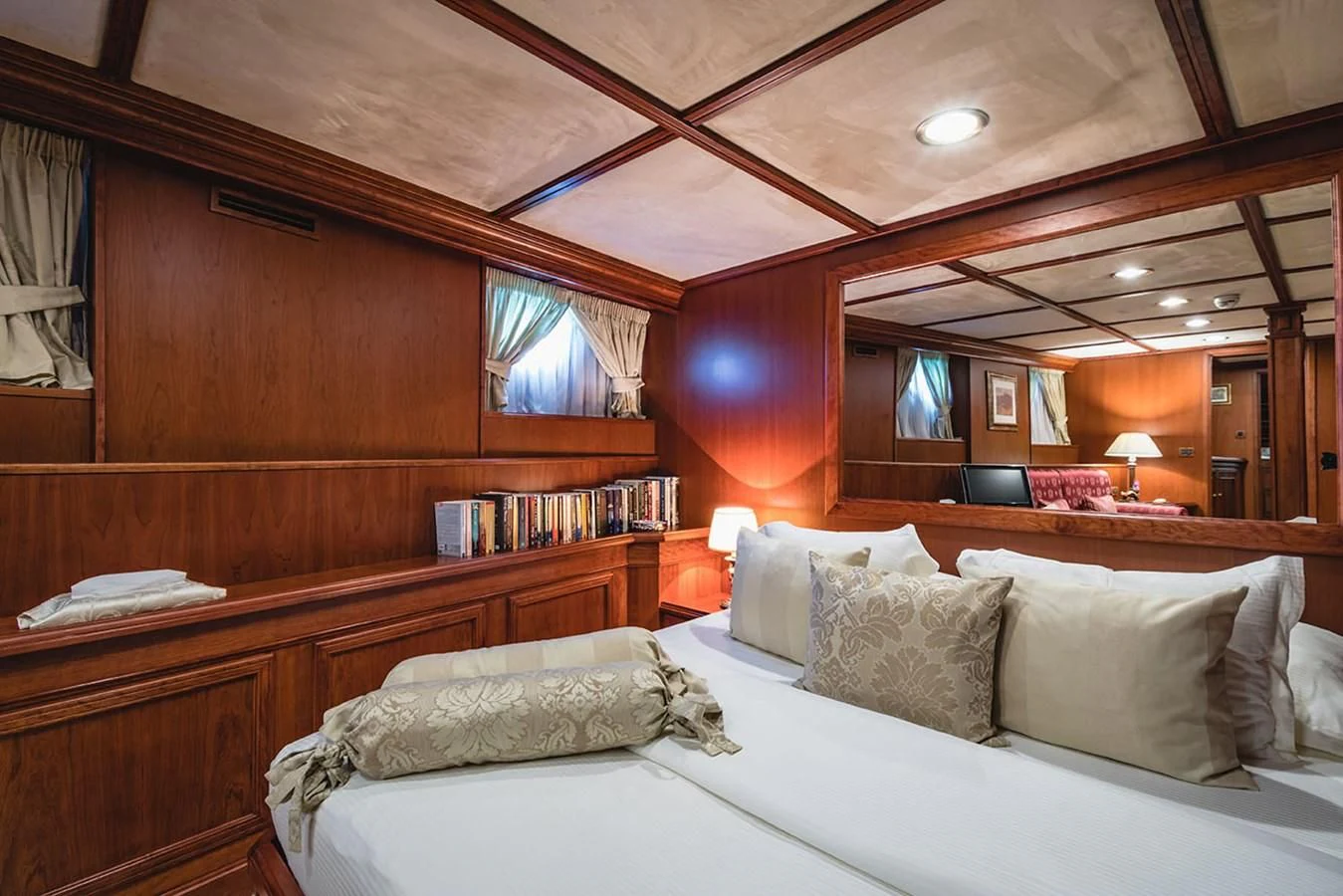 a room with a bed and a bookcase aboard SEAGULL II Yacht for Sale
