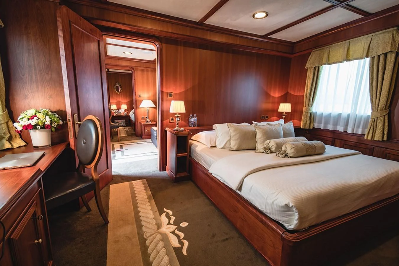 a bedroom with a bed and a desk aboard SEAGULL II Yacht for Sale