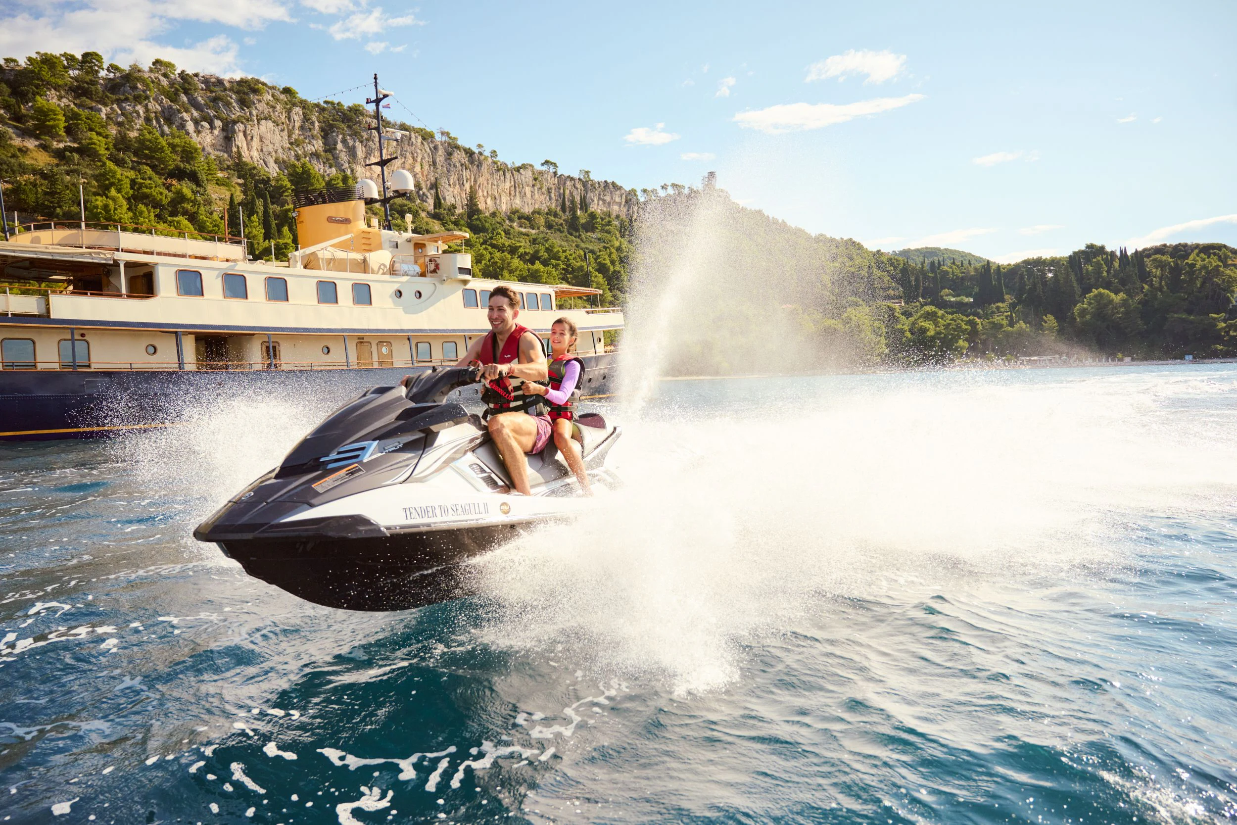 a couple of people on a speed boat in the water aboard SEAGULL II Yacht for Sale