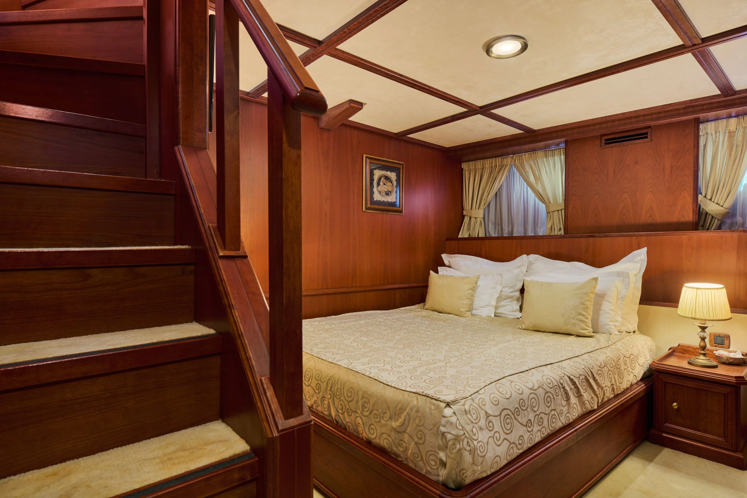a bed with a wooden headboard aboard SEAGULL II Yacht for Sale