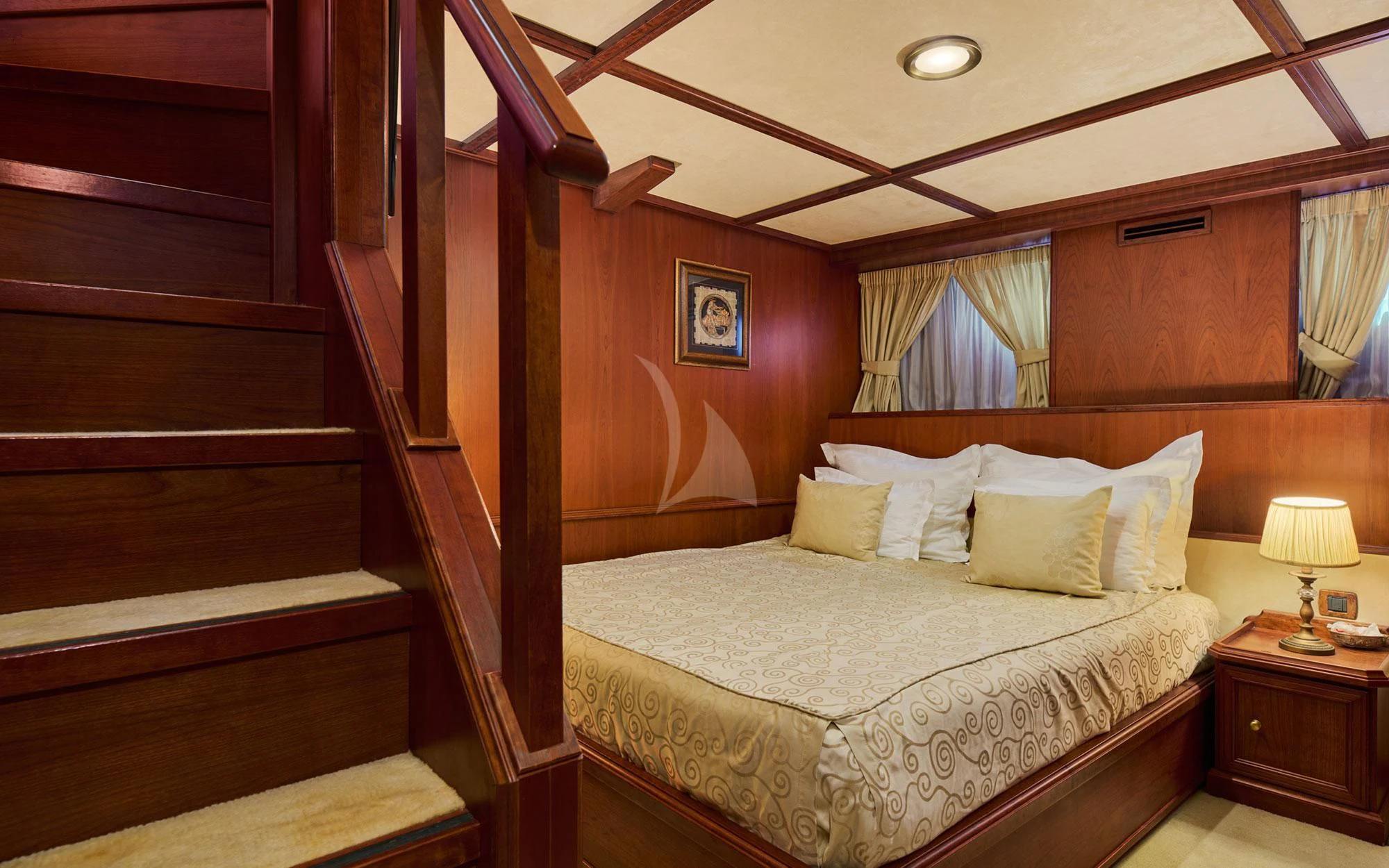 a bed with a wooden headboard aboard SEAGULL II Yacht for Sale