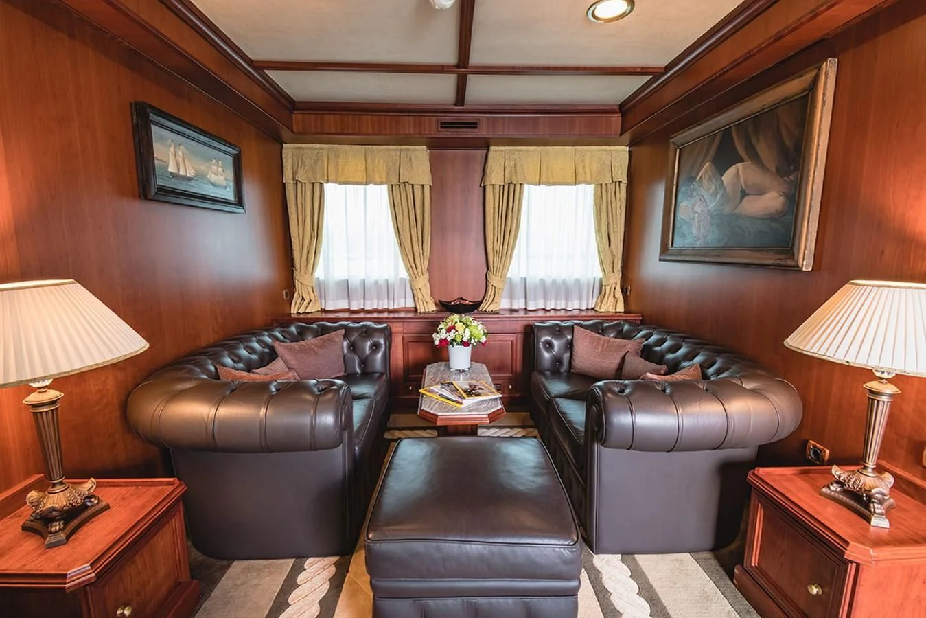 a living room with leather couches and a coffee table aboard SEAGULL II Yacht for Sale