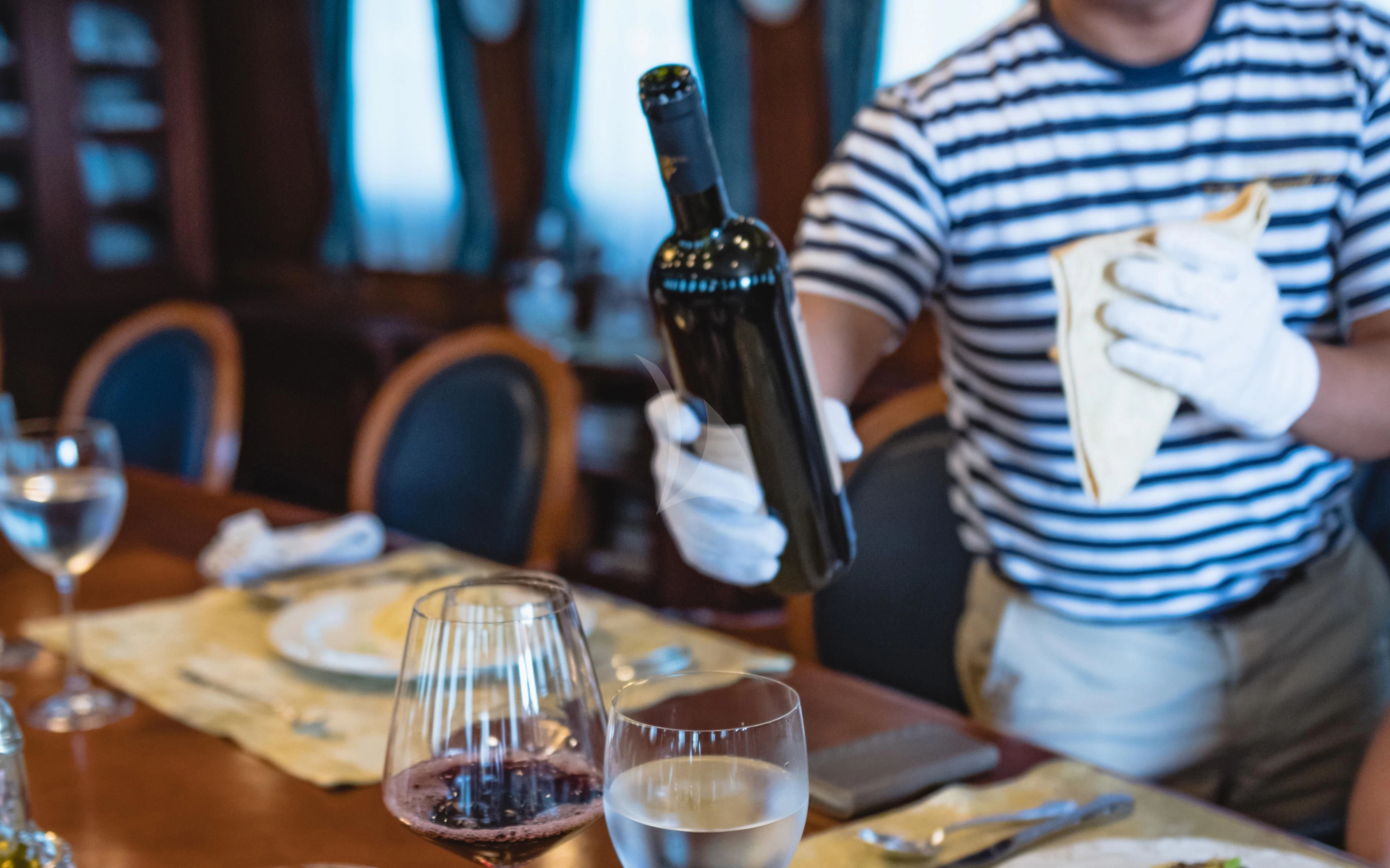 a person holding a bottle of wine aboard SEAGULL II Yacht for Sale