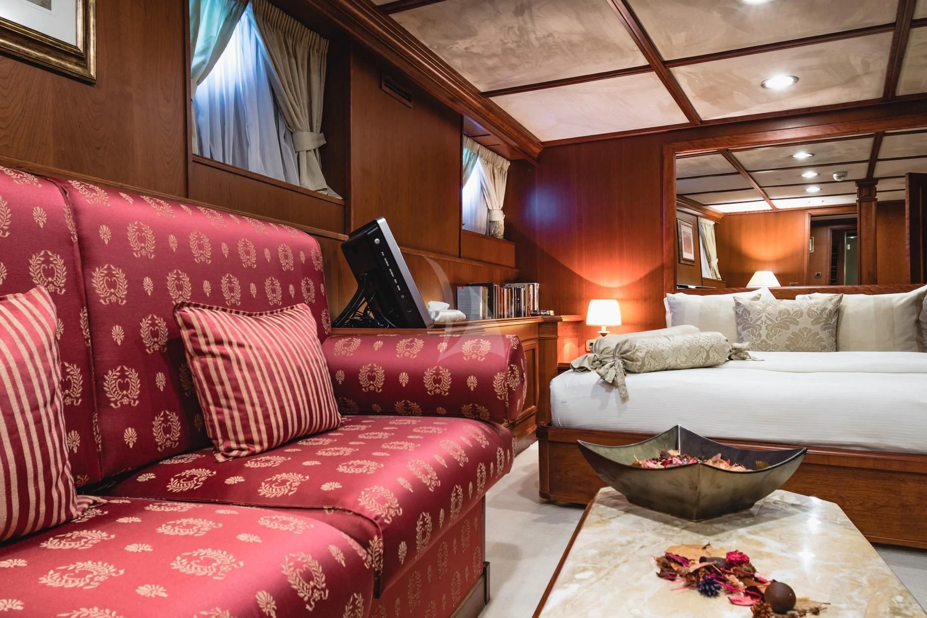 a living room with a red couch aboard SEAGULL II Yacht for Sale