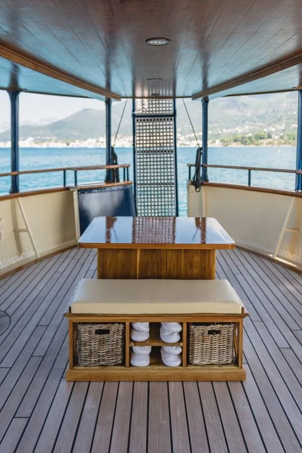a wood table on a deck aboard SEAGULL II Yacht for Sale