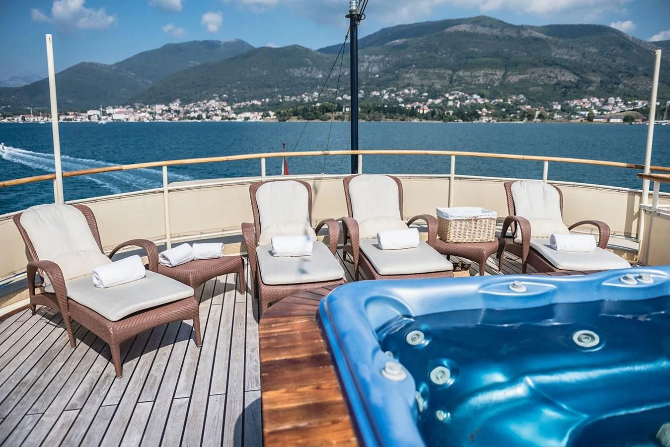 a table and chairs on a deck overlooking a large city aboard SEAGULL II Yacht for Sale