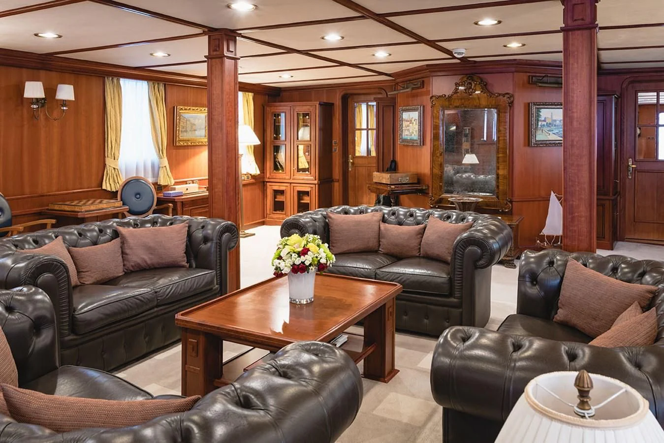 a living room with leather couches and a coffee table aboard SEAGULL II Yacht for Sale