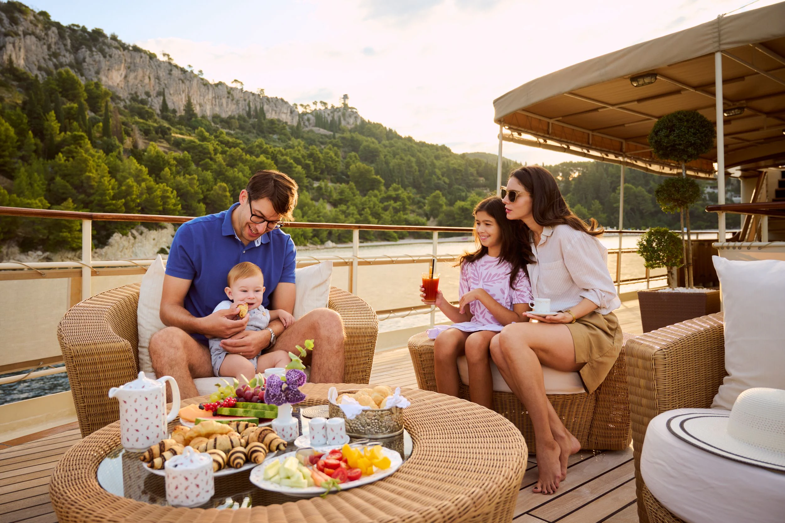 a family sitting on a couch aboard SEAGULL II Yacht for Sale