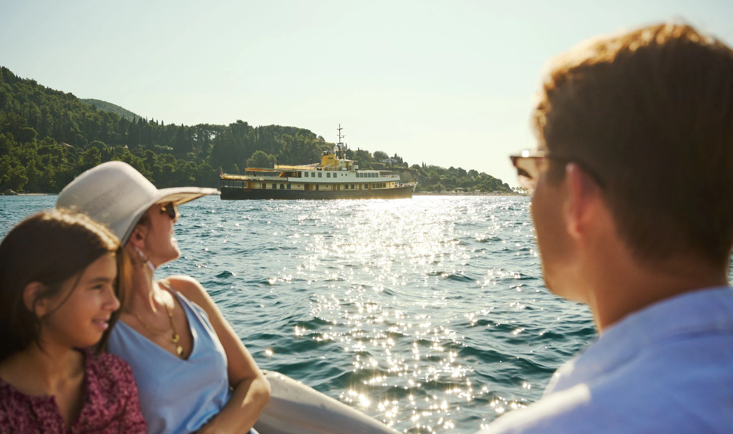 a group of people on a boat looking at a large ship in the water aboard SEAGULL II Yacht for Sale