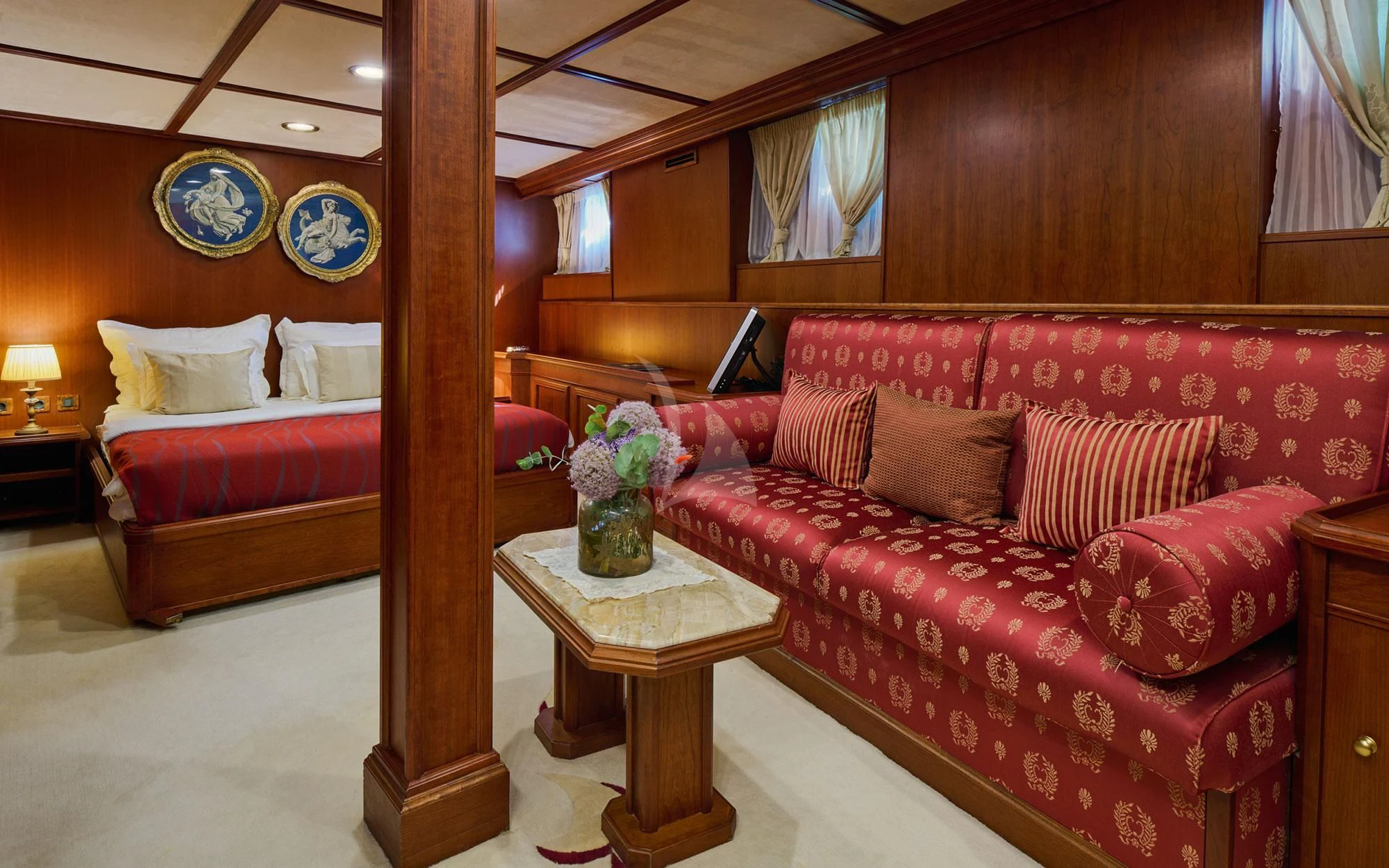 a living room with a red couch aboard SEAGULL II Yacht for Sale
