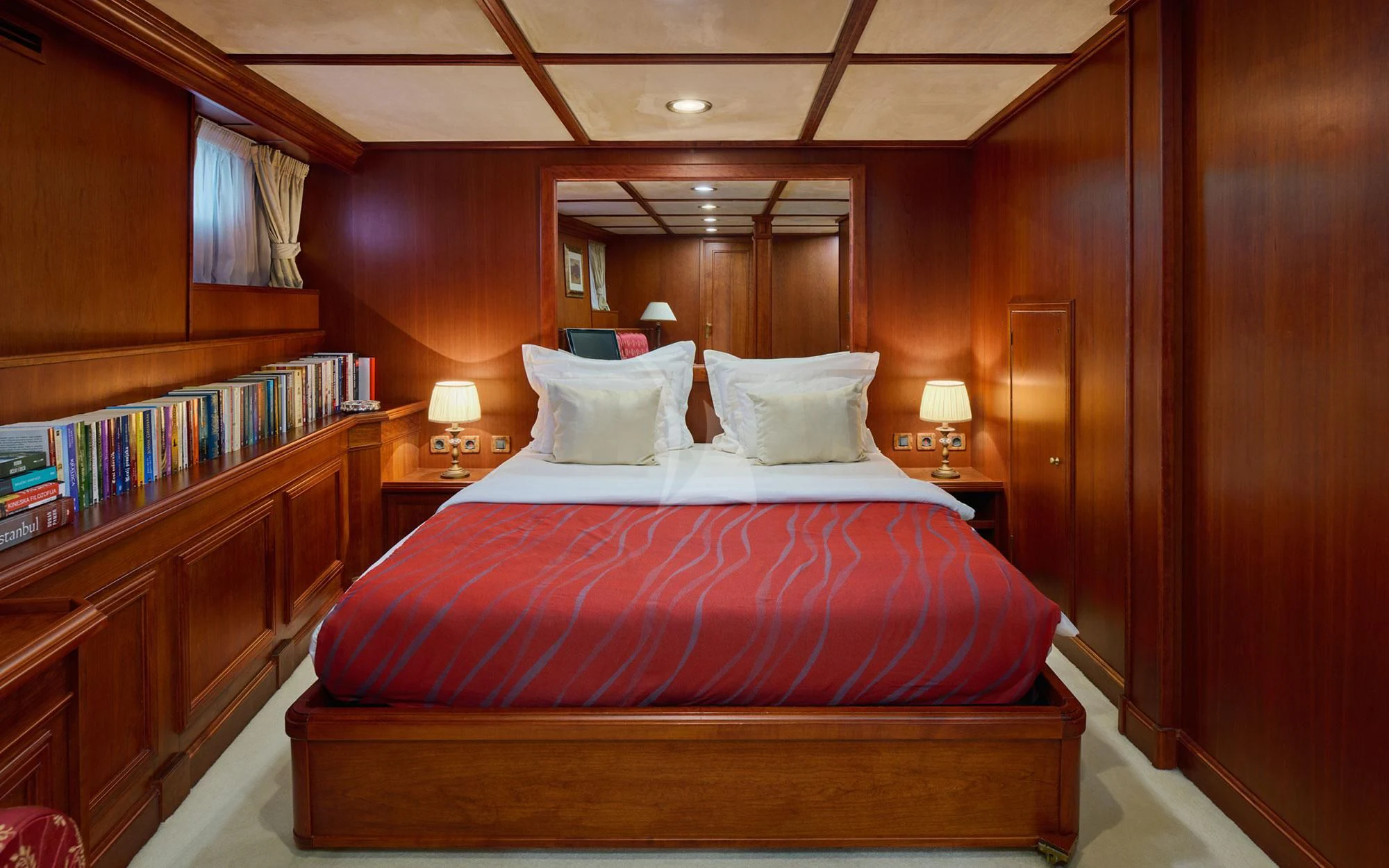 a bed with a red comforter aboard SEAGULL II Yacht for Sale