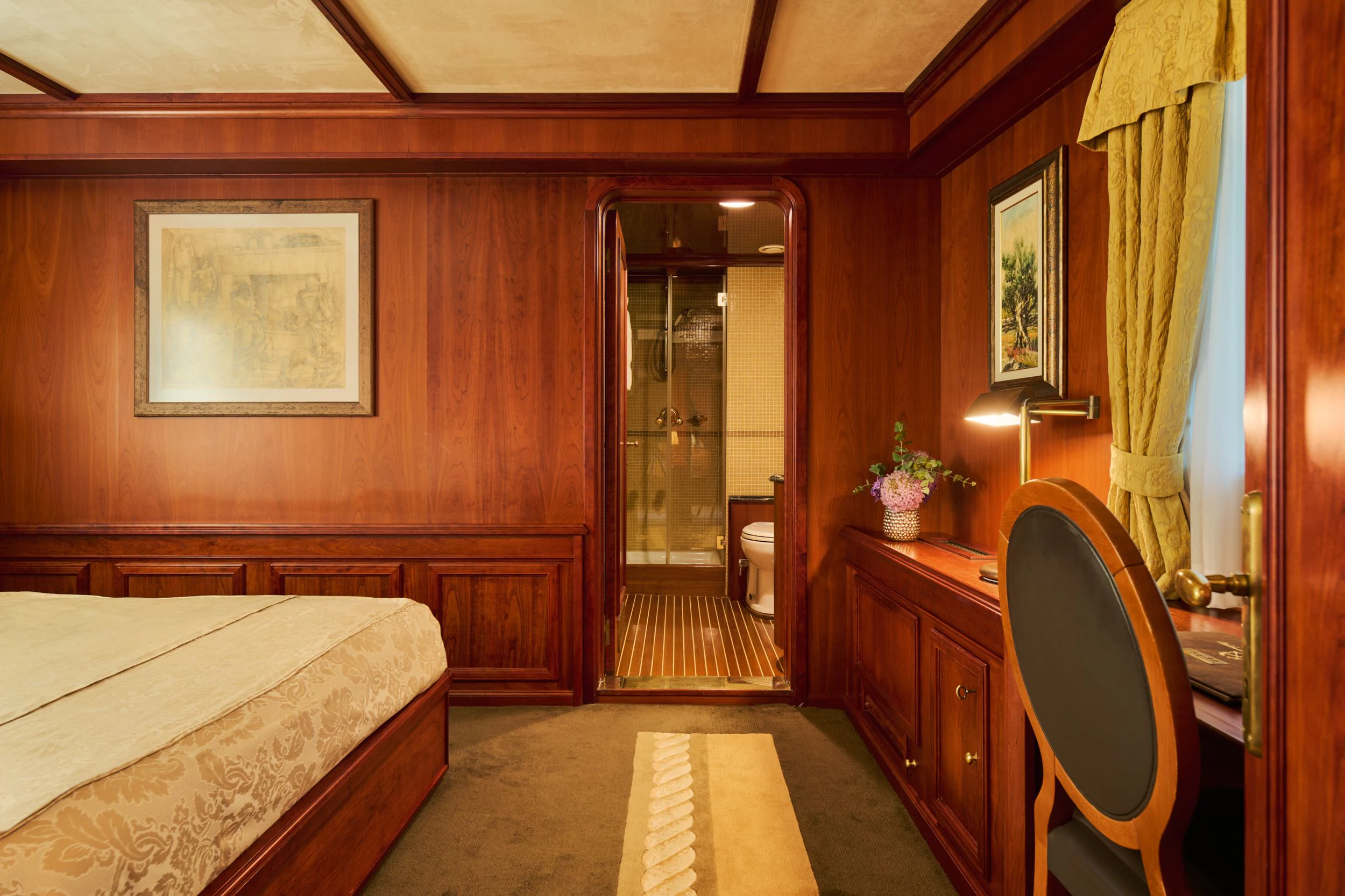 a bedroom with a bed and a desk aboard SEAGULL II Yacht for Sale