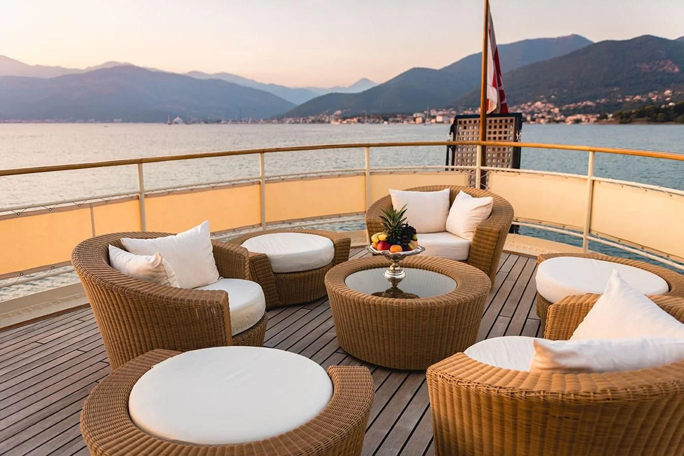 a patio with chairs and a table with a flag on it aboard SEAGULL II Yacht for Sale