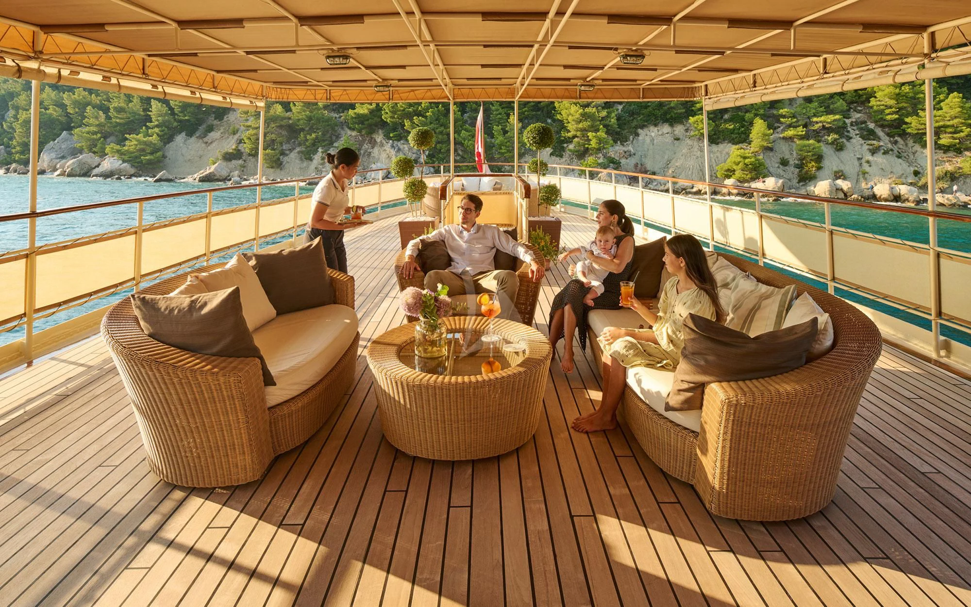a group of people sitting on a couch on a deck aboard SEAGULL II Yacht for Sale