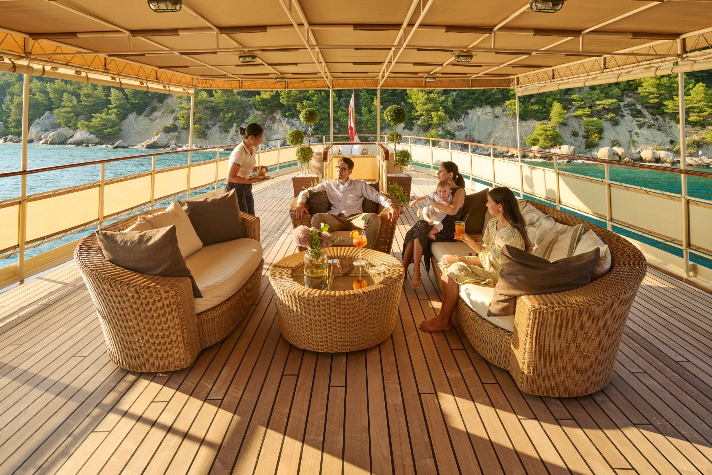 a group of people sitting on a couch on a deck aboard SEAGULL II Yacht for Sale