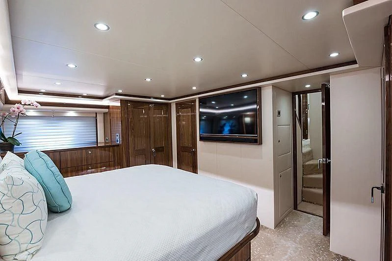 a bedroom with a bed and a television aboard PARTY OF FIVE Yacht for Sale