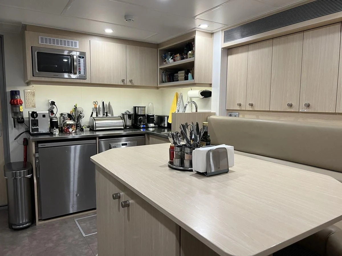 a kitchen with white cabinets aboard BAD COMPANY SUPPORT Yacht for Charter