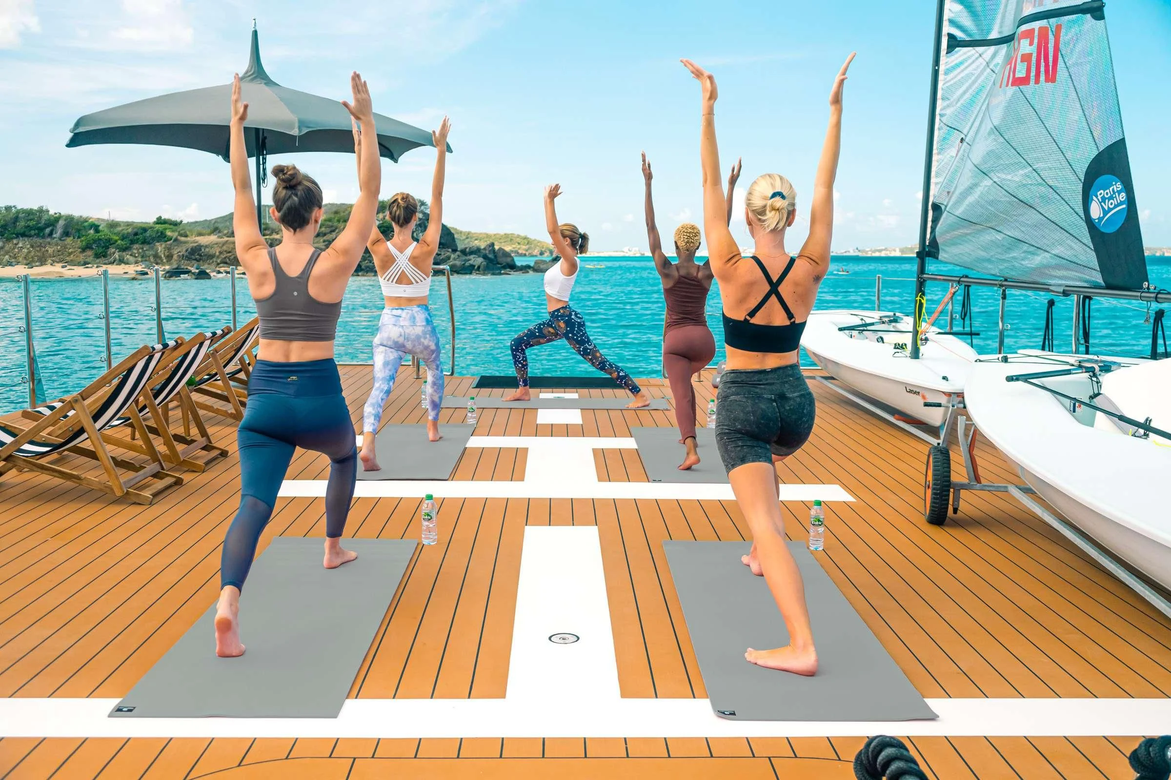 a group of women dancing on a deck aboard BAD COMPANY SUPPORT Yacht for Charter