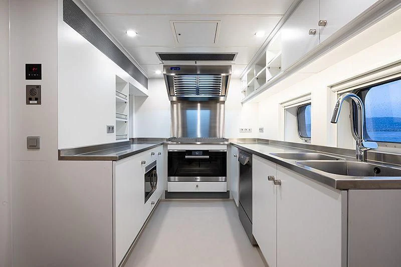 a kitchen with white cabinets aboard BAD COMPANY SUPPORT Yacht for Charter