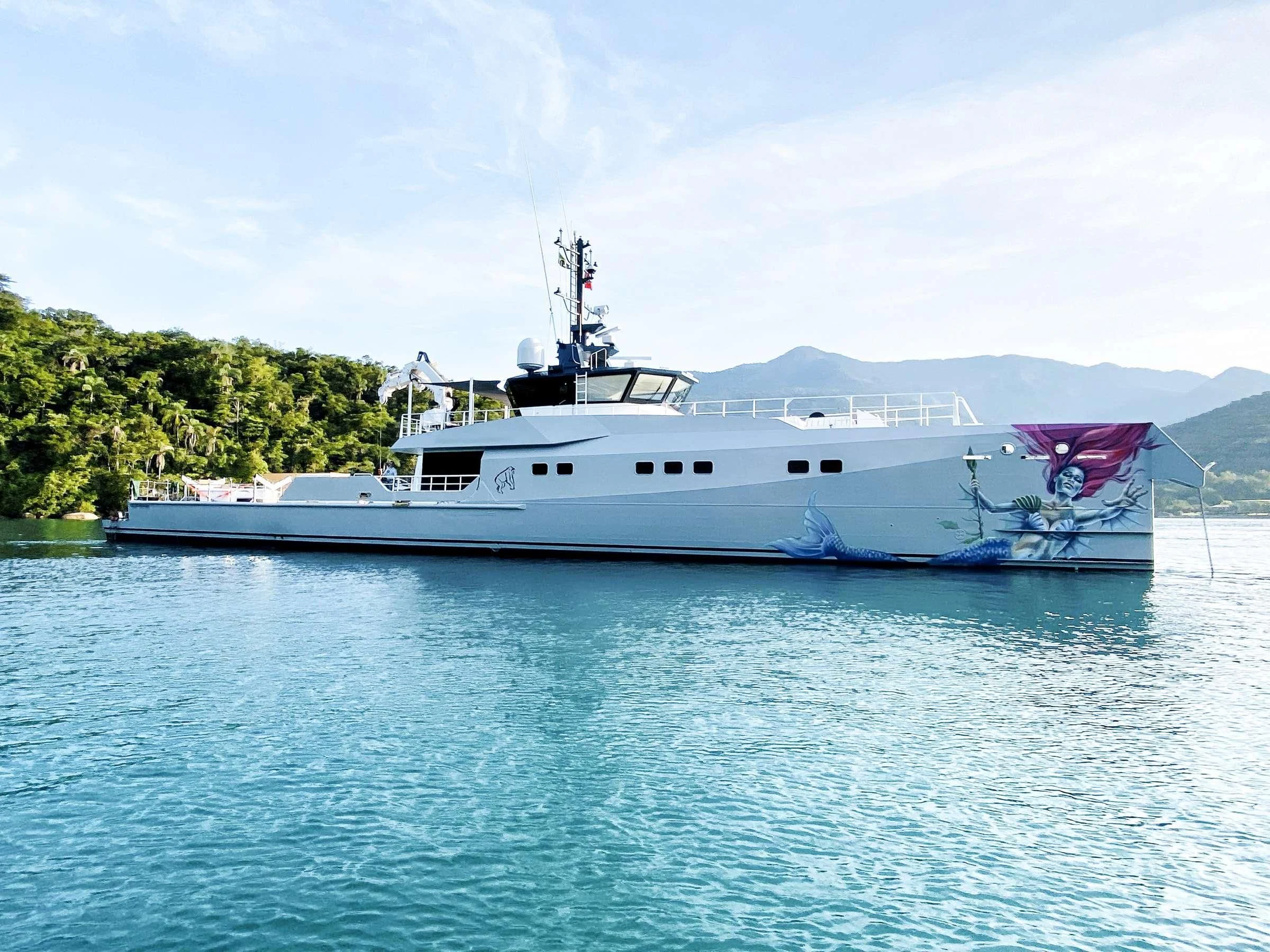a large white boat in the water aboard BAD COMPANY SUPPORT Yacht for Charter