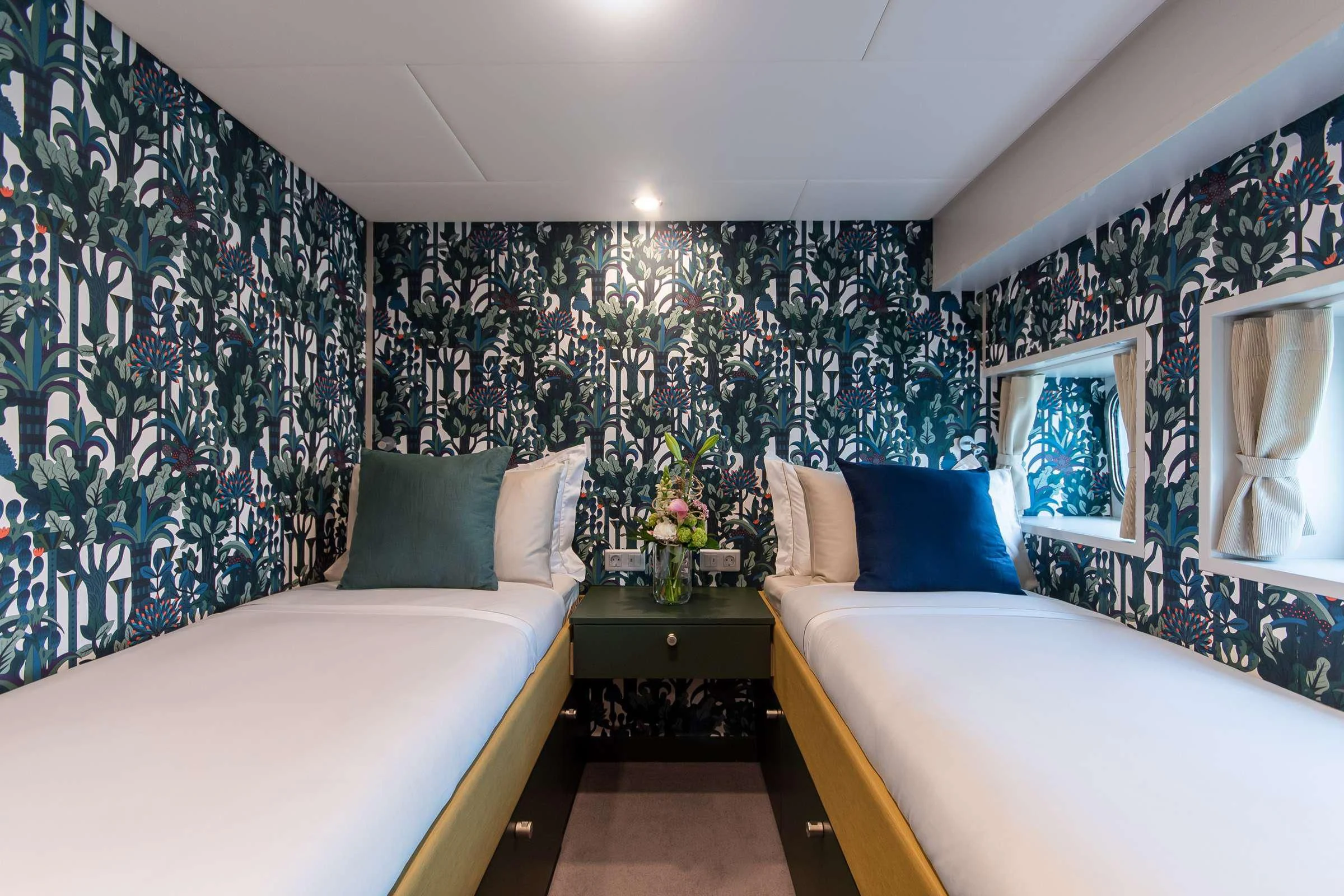a bedroom with two beds aboard BAD COMPANY SUPPORT Yacht for Charter