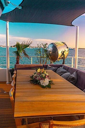 a table with flowers and a globe on it aboard BAD COMPANY SUPPORT Yacht for Charter