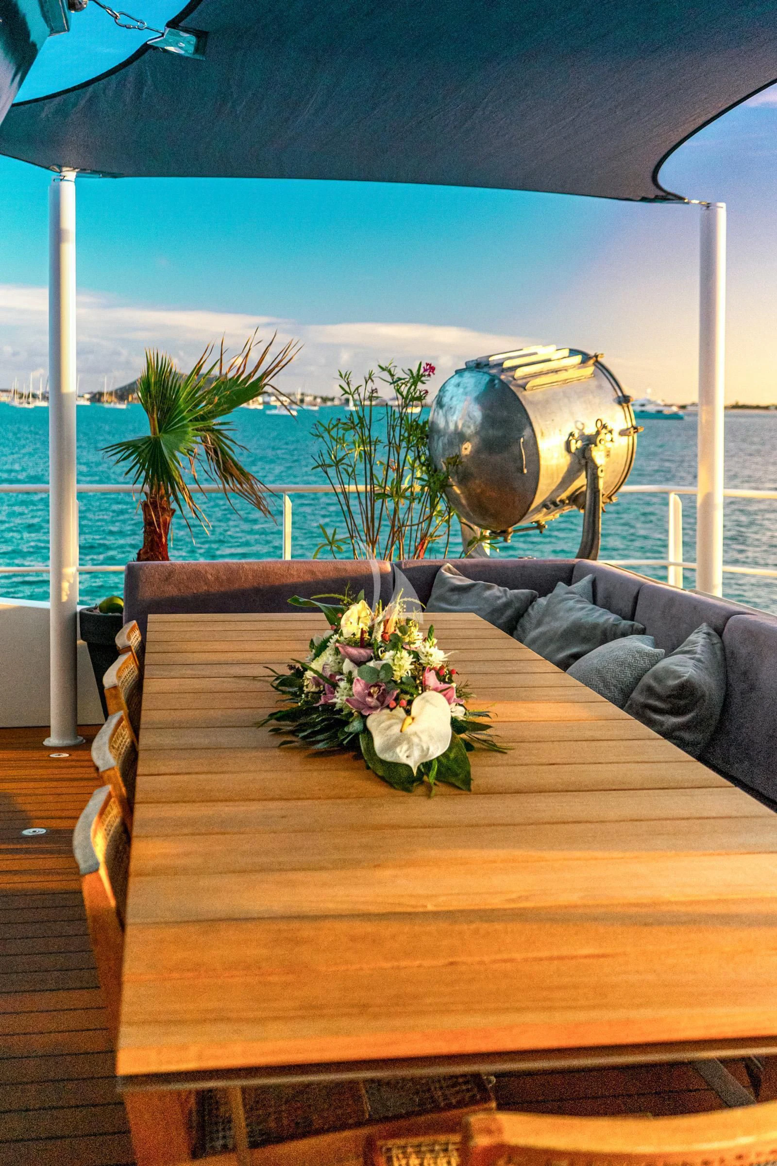 a wooden table with a statue on it aboard BAD COMPANY SUPPORT Yacht for Charter