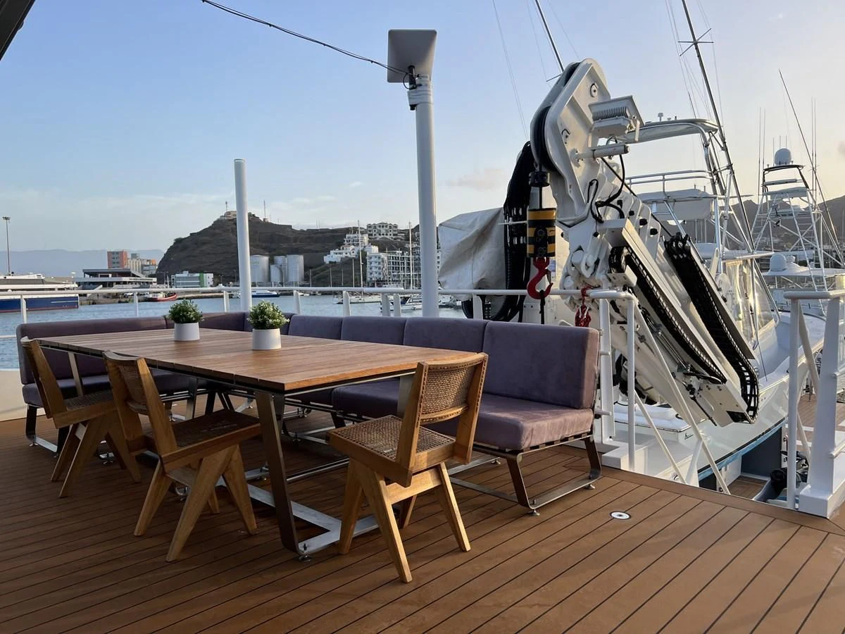 a deck with a table and chairs aboard BAD COMPANY SUPPORT Yacht for Charter