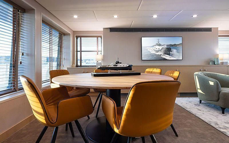 a room with a table and chairs aboard BAD COMPANY SUPPORT Yacht for Charter