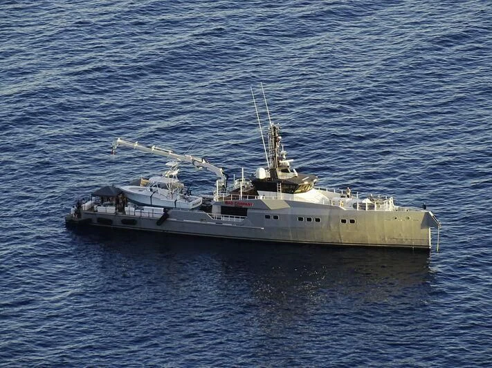 a large ship in the water aboard BAD COMPANY SUPPORT Yacht for Charter