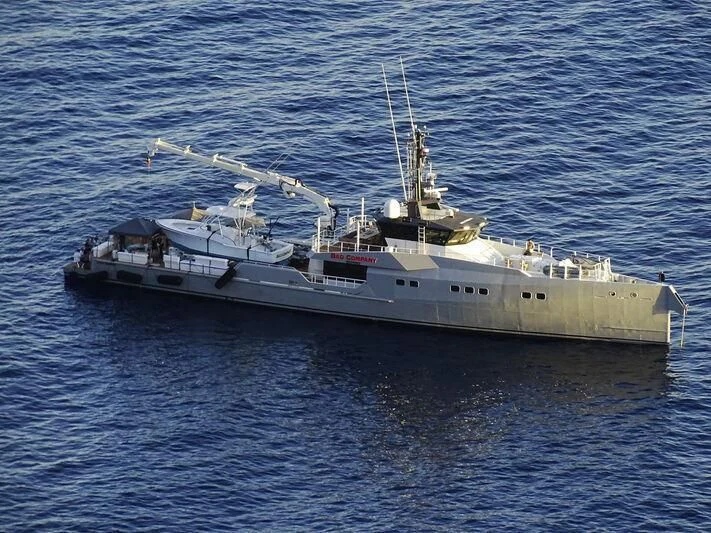 a large ship in the water aboard BAD COMPANY SUPPORT Yacht for Charter