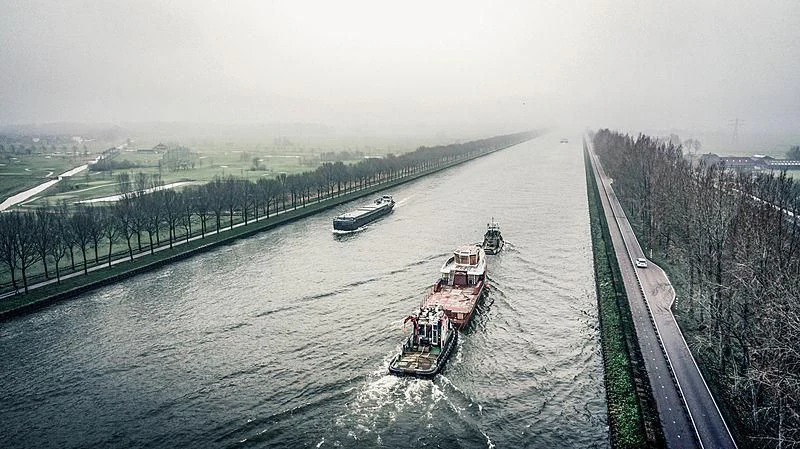 a group of ships on a river with Vietnam Veterans Memorial in the background aboard BAD COMPANY SUPPORT Yacht for Charter