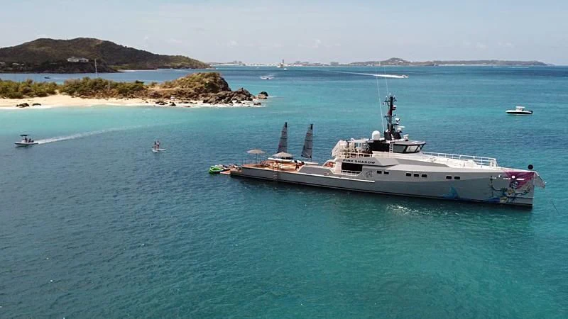 a large white boat in the water aboard BAD COMPANY SUPPORT Yacht for Charter