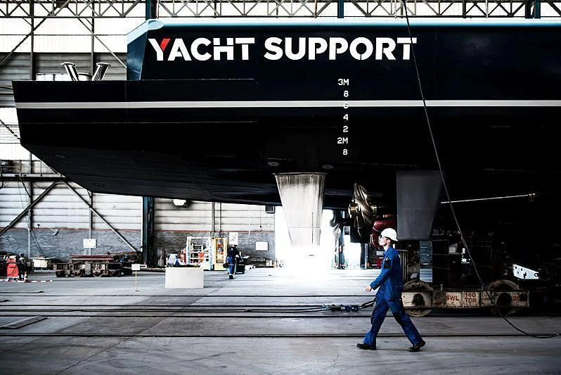 a person walking in front of a large metal structure aboard BAD COMPANY SUPPORT Yacht for Charter