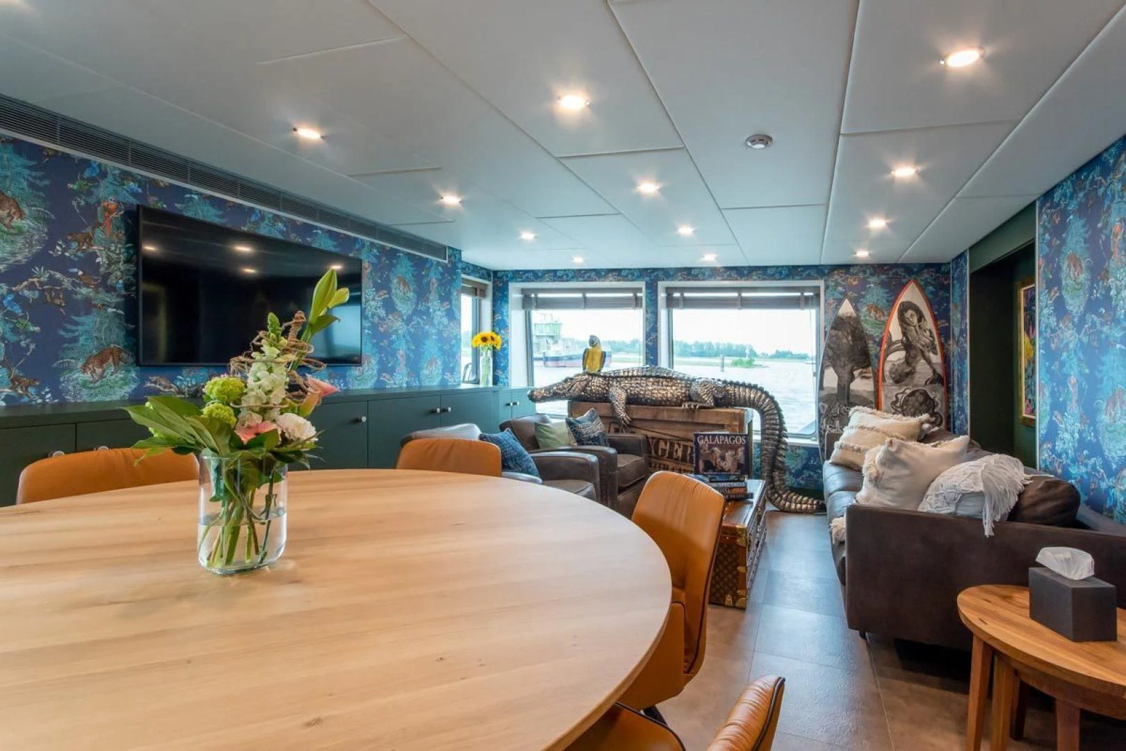 a living room with a vase of flowers on a table aboard BAD COMPANY SUPPORT Yacht for Charter