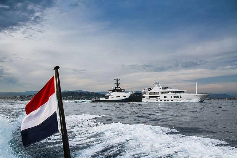 a flag and a boat in the water aboard BAD COMPANY SUPPORT Yacht for Charter