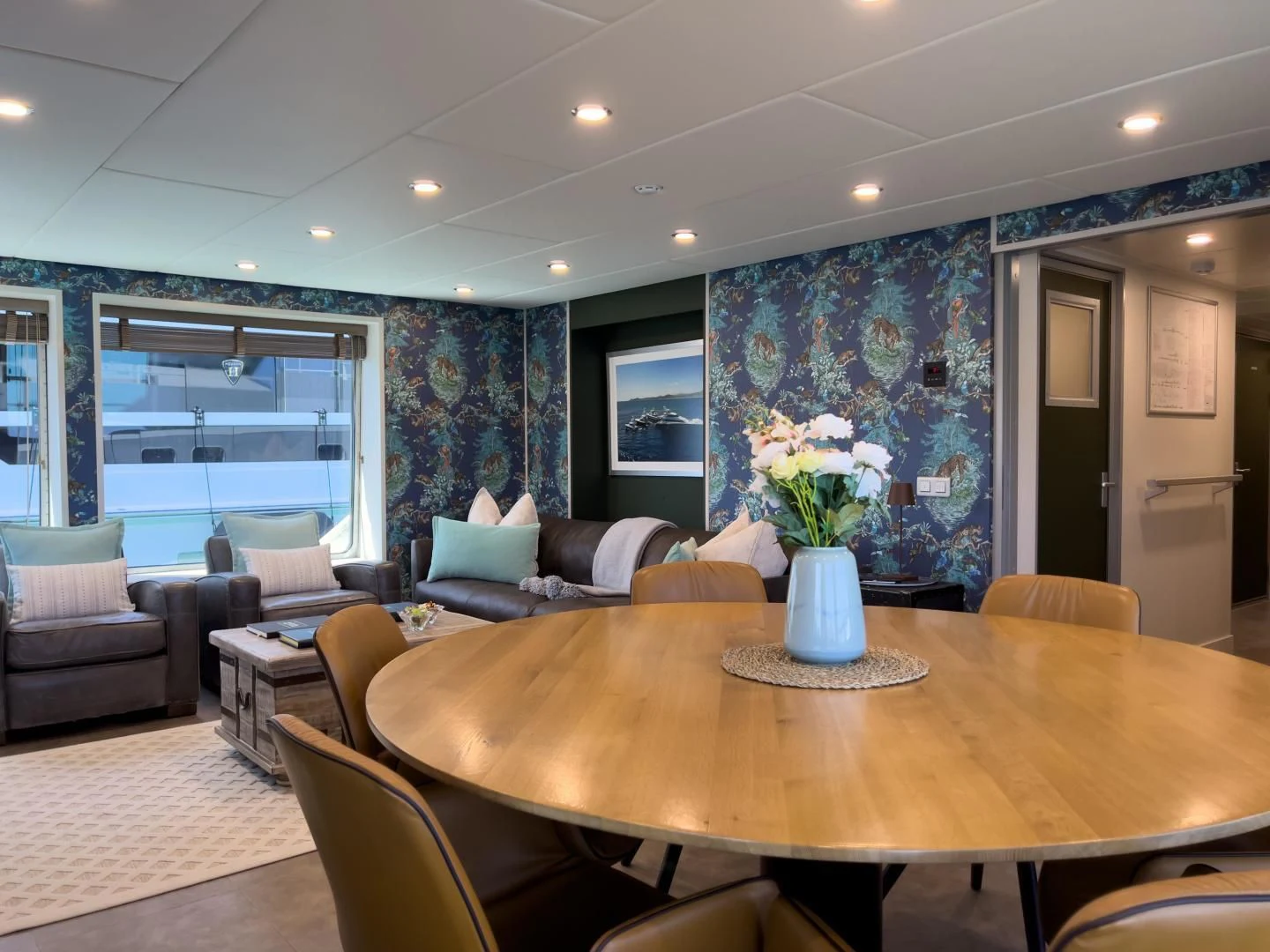 a large living room with a table and chairs aboard BAD COMPANY SUPPORT Yacht for Charter