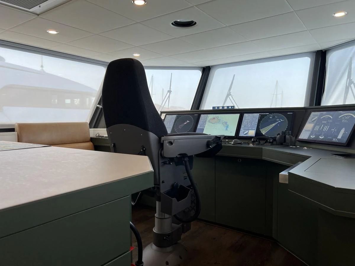 a room with a desk and chairs aboard BAD COMPANY SUPPORT Yacht for Charter