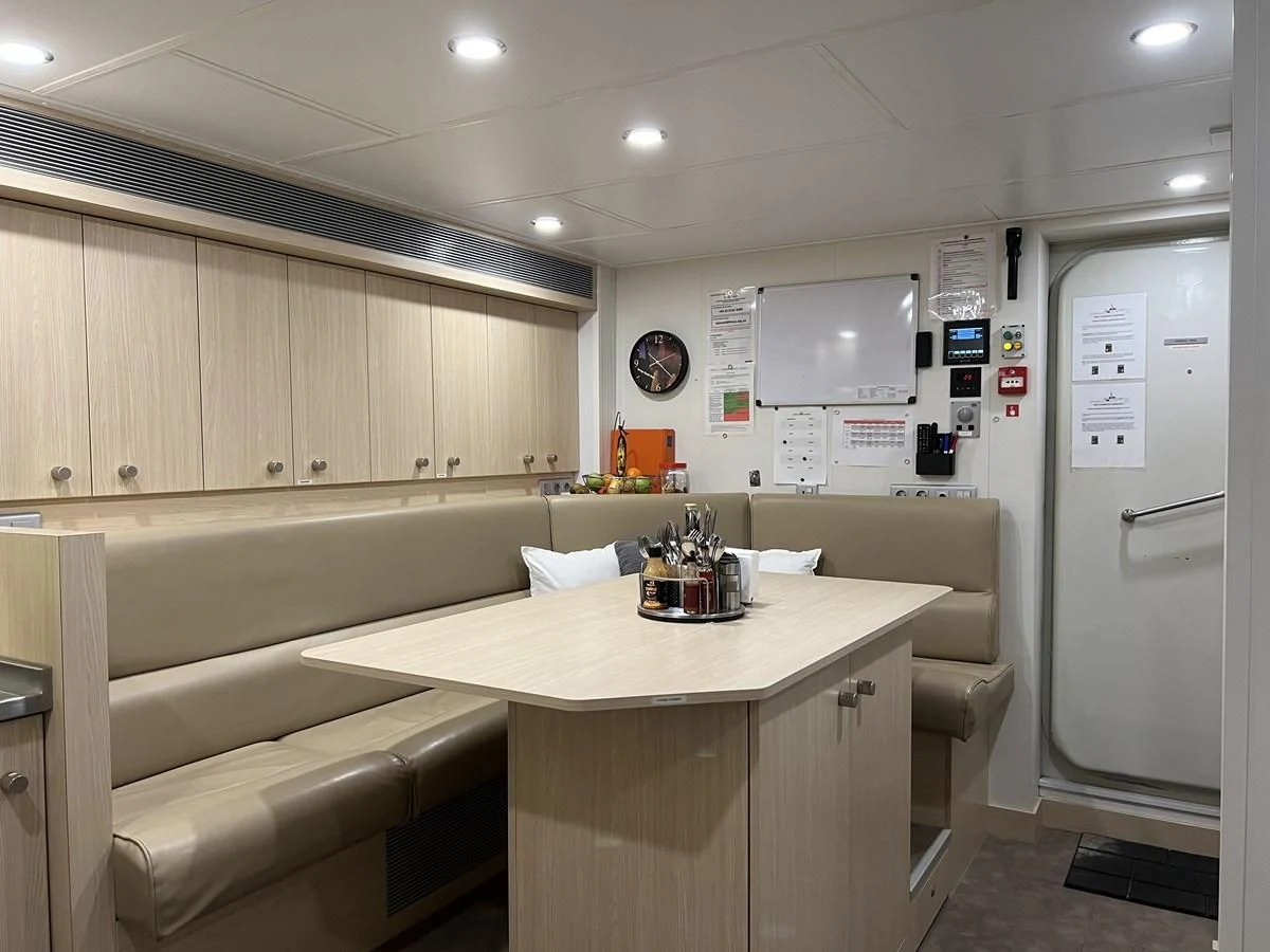 a kitchen with a table and chairs aboard BAD COMPANY SUPPORT Yacht for Charter