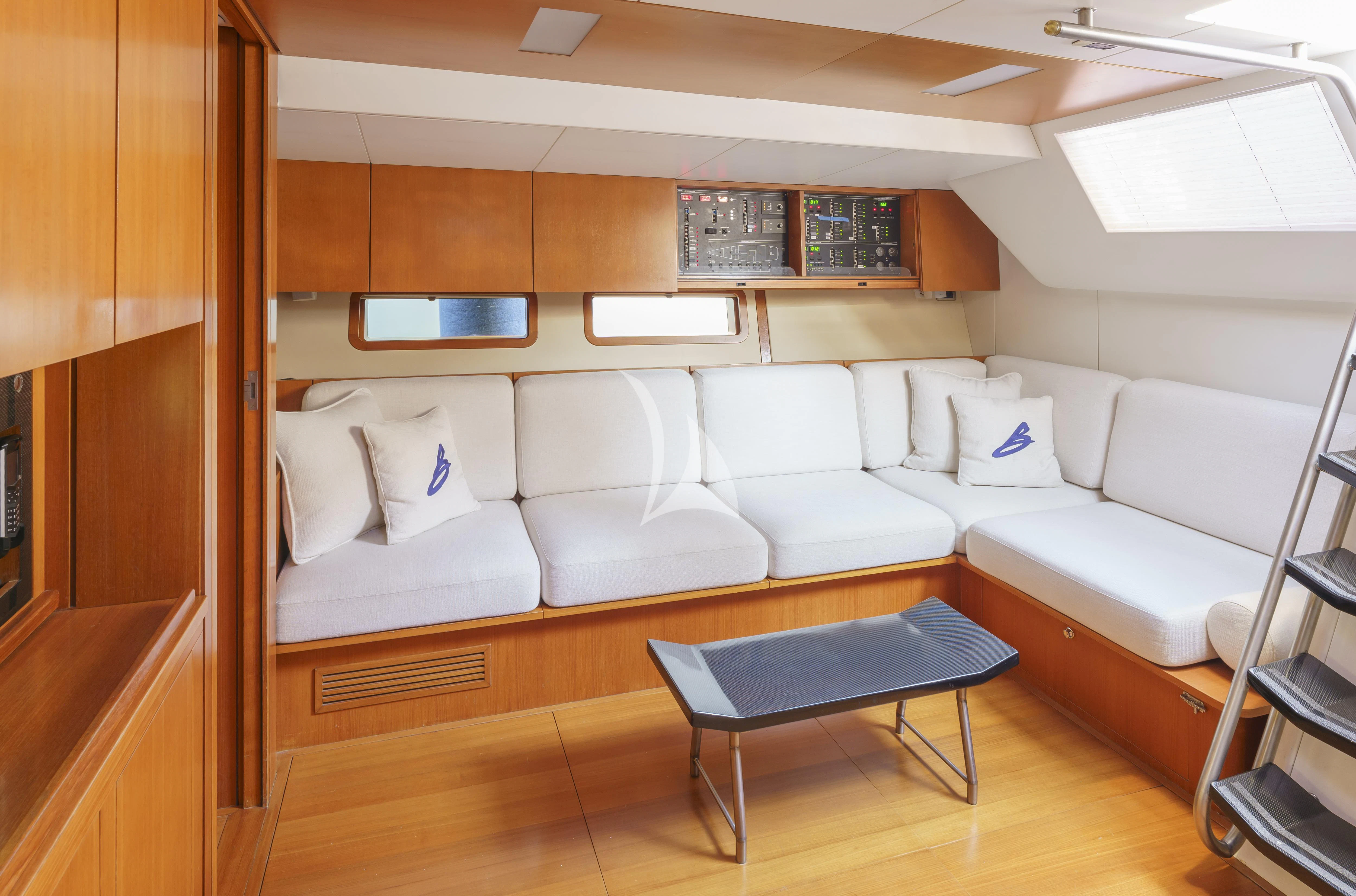 a room with a couch and a table aboard BOMBARDA Yacht for Sale